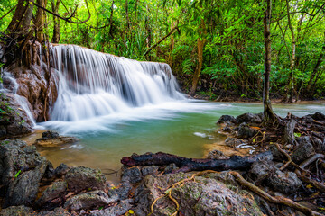 Obraz premium Waterfall and blue emerald water color in Huay Mae Khamin national park. Huay Mae Khamin, Beautiful nature rock waterfall steps in tropical rainforest at Kanchanaburi province, Thailand
