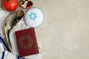 Flat lay composition with Rosh Hashanah holiday symbols on grey table. Space for text