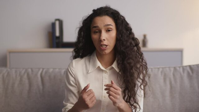 Psychologist pov portrait of young emotional annoyed woman talking to camera, complaining about life problems