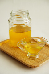 Freshly made liquid homemade ghee butter oil. Healthy food concept. Ayurveda product