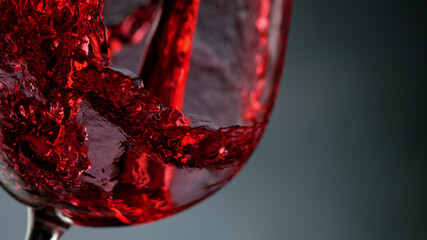 Glass of red wine on dark background closeup