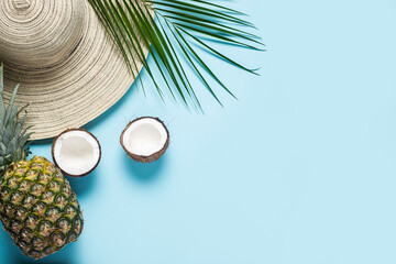 Women's hat with wide brim, tropical fruits and a branch of a palm tree on a blue background....