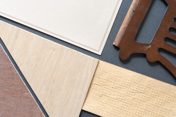 beige and yellow ochre patterned paper, unfinished wood panel cut-offs, with decorative wood object...