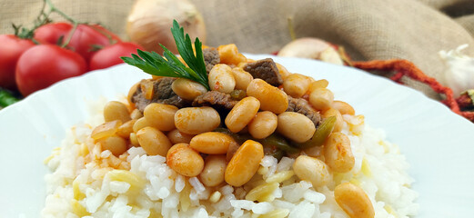 Hot turkish bean stew with a tasty tomato sauce and rice turkish pilav