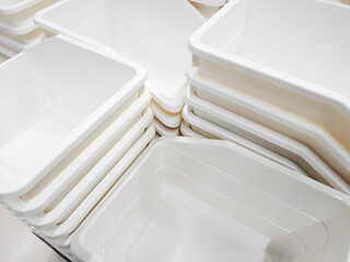 Stack of white plastic container box storage. Plastic containers for home use stack in a store for...