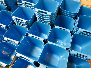 Stack of blue plastic container box storage. Plastic containers for home use stack in a store for sale. Houseware store plastic containers.