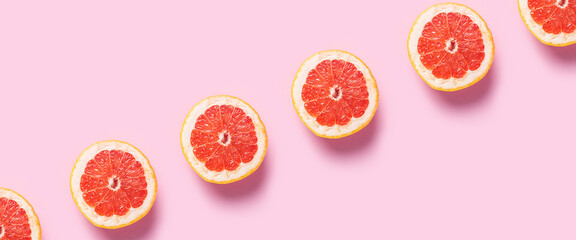 Half grapefruit on a pink background. Pattern. Banner. Flat lay, top view