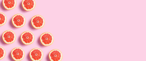 Half grapefruit on a pink background. Pattern. Banner. Flat lay, top view