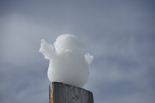 snowman on a wooden pole