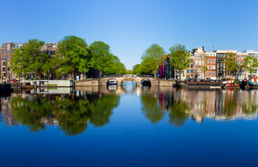 Fototapeta na wymiar Dutch bridge over the amsterdam canal near the amstel