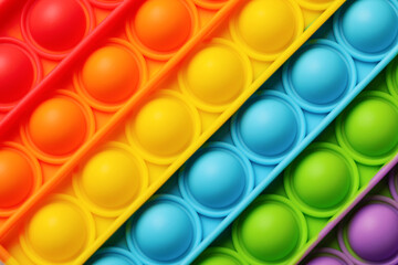 Rainbow pop it fidget toy as background, closeup - obrazy, fototapety, plakaty