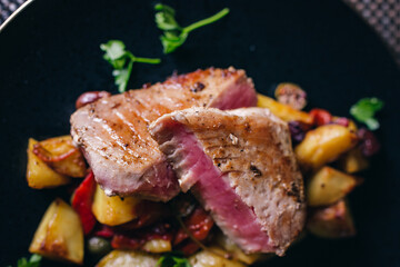 tuna steak on black plate