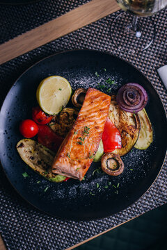 grilled fish with vegetables served on plate