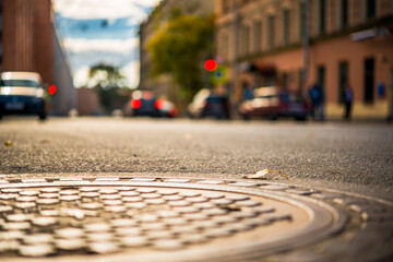 Autumn in the city, the street with parked cars. View from the hatch on the pavement level