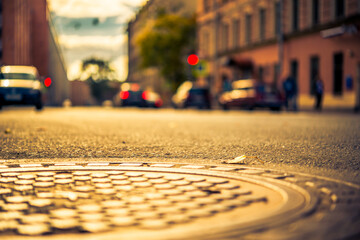 Autumn in the city, the street with parked cars. View from the hatch on the pavement level
