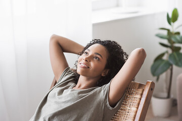 Young woman relaxing at home. African american girl resting in her room. Enjoy life, rest,...