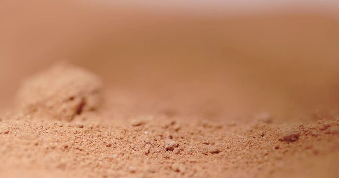 Powder flowing as sand like object closeup