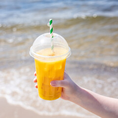 ice drink on the beach cold lemonade soda beverage fresh juice, sea coast shore, summer surf wave background refreshing relax positive mood vacation top view