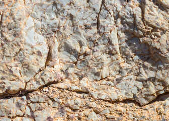 The rough surface of granite stone up-close.