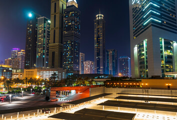 Fototapeta na wymiar Dubai, UAE - 05.28.2021 Shot of a Dubai International Financial center and Sheikh Zayed road at night. Modern architecture