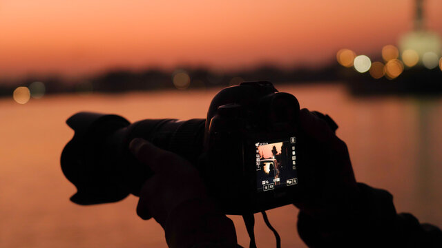 Silhouette of a camera capturing the sunset