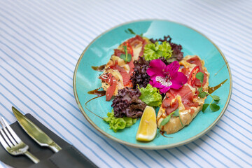 A plate with bruschetta with salmon and curd cheese. Sandwich with smoked salmon.