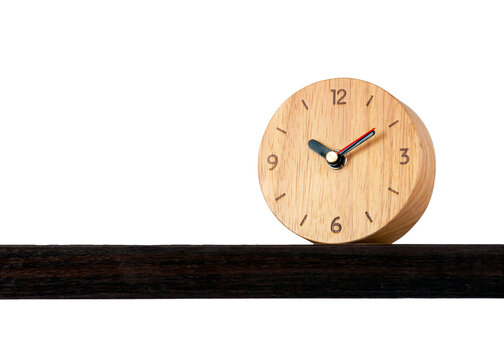 Brown alarm retro classic wooden design clock placing on shelf with ten o'clock isolated white background