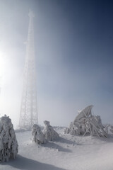 mobile phone base station pole on a sunny cloudy and foggy day