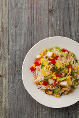 Salad with rice, chicken, peanuts and vegetables. Top view.