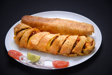 Chicken Spring Rolls with salad in white plate 