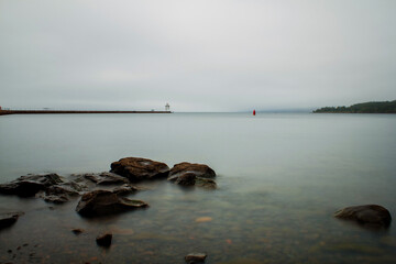 Agate Bay, Two Harbors, Minnesota on a foggy morning with lighthouse in background.