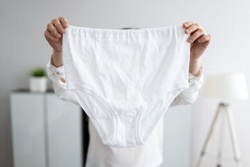 Woman Holding Loose Granny Underwear