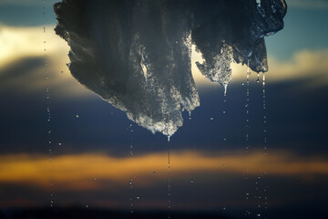 the ice hanging from the roof is melting