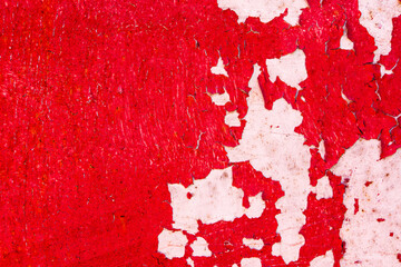 Metal wall covered with red paint peeling off