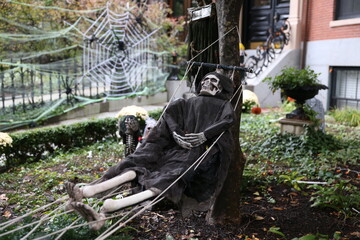skeleton in a hammock. Halloween decorations outside
