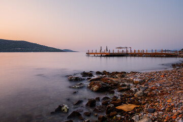 sunset over bay in Aegean sea. Torba, Bodrum, Turkey. October 2020. Long exposure picture