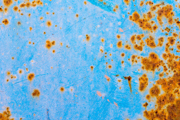 Rusty and crumbling blue steel wall