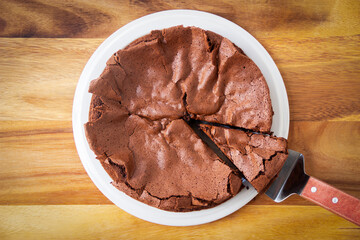 Homemade flourless chocolate cake. Free gluten dessert. Top view on wooden background.