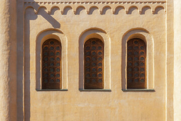 Fototapeta premium Old wooden windows with round glasses in the wall. Kyiv, Ukraine