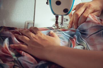 A seamstress quickly tailors the clothes. In order to deliver customers in time to see the top view