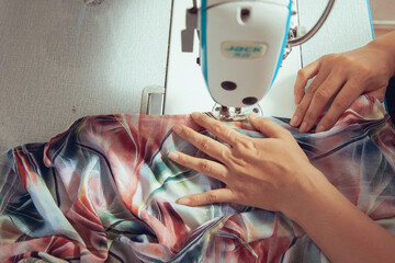 A seamstress quickly tailors the clothes. In order to deliver customers in time to see the top view
