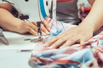 A seamstress quickly tailors the clothes. In order to deliver customers in time to see the top view