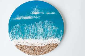 Resin art painting with blue sea waves and beach on white background