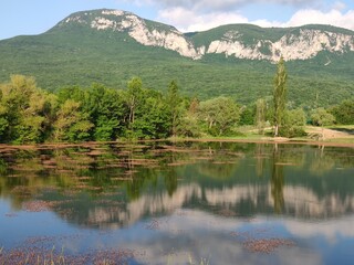 Crimean peninsula. Summer landscape in the mountainous Crimea with a lake, trees and clouds.