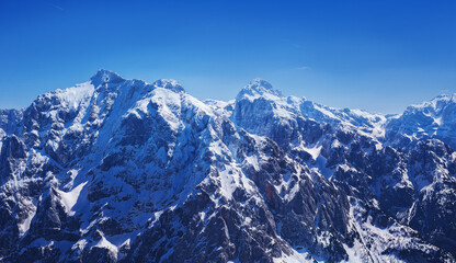 Fototapeta na wymiar severe view of spring still snowy slovenian alps Mala Mojstrovka