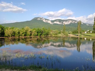 Crimean peninsula. Summer landscape in the mountainous Crimea with a lake, trees and clouds.