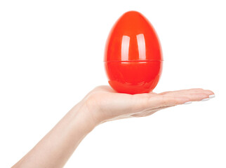 Hand with red plastic egg isolated on white background.