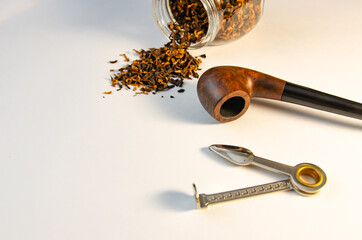 Tobacco and tobacco pipes on a white background in the soft morning sunlight. Soft focus image

