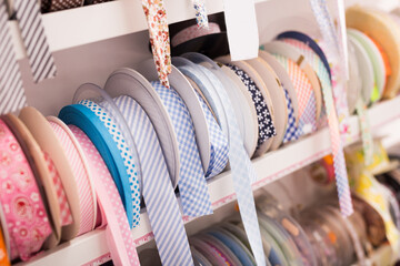 Colorful ribbons, webbing, braid, bias tapes, cords for sewing or needlecraft on store showcase
