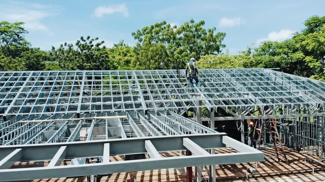 Metal roof structure, structural framing steel studs in green remote residential construction site project. Eco built architectural engineering framework design. Modern aerial perspective, builders 